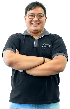 Staff portrait of a technical team member in company uniform posing in an office environment.